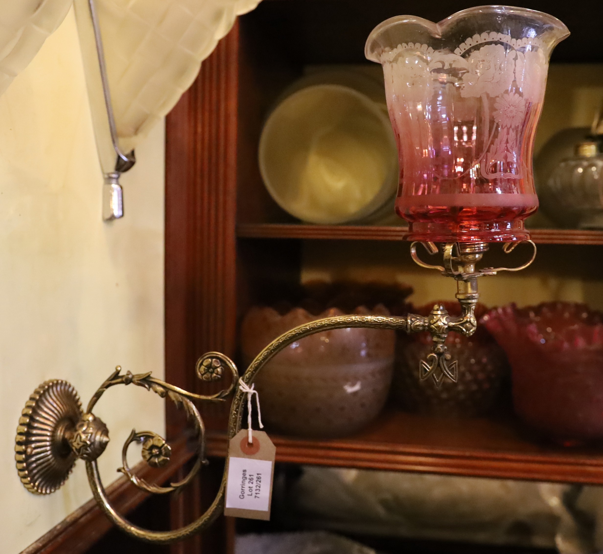 A Victorian brass gasolier wall light with cranberry tinted etched glass shade, now converted to electricity, height 38cm. depth 38cm